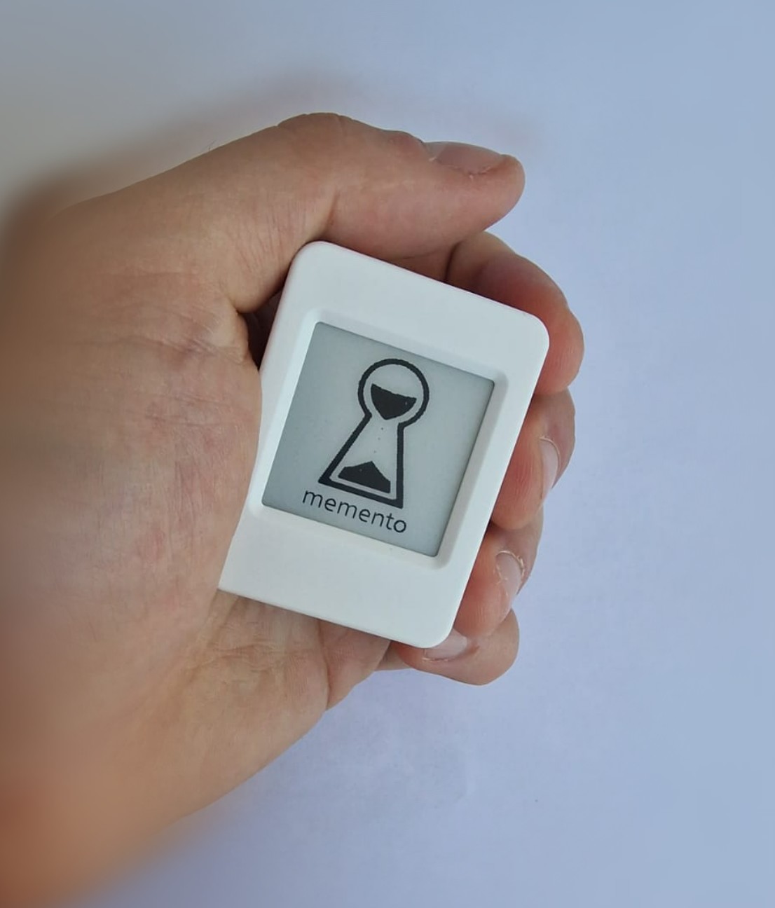 The Memento device held in a hand